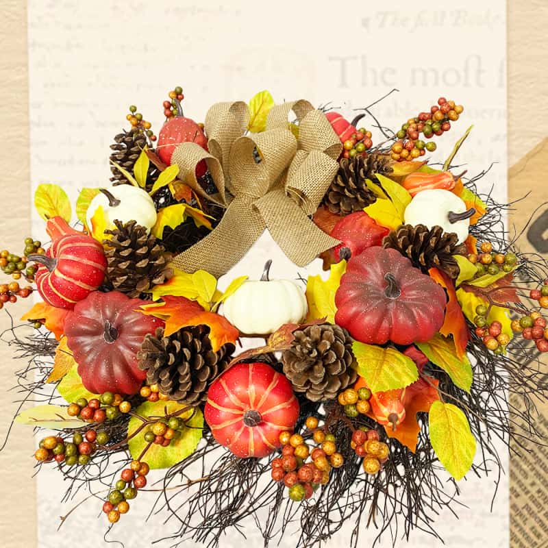 Autumn wreath with pumpkin and berries